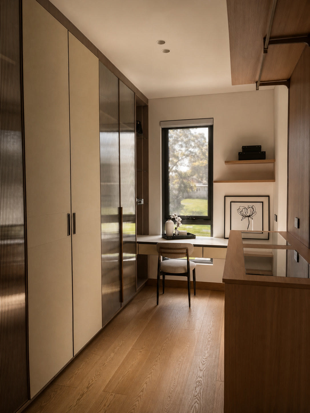 Study corner with floor-to-ceiling wardrobes, a desk beneath a window and timber floors