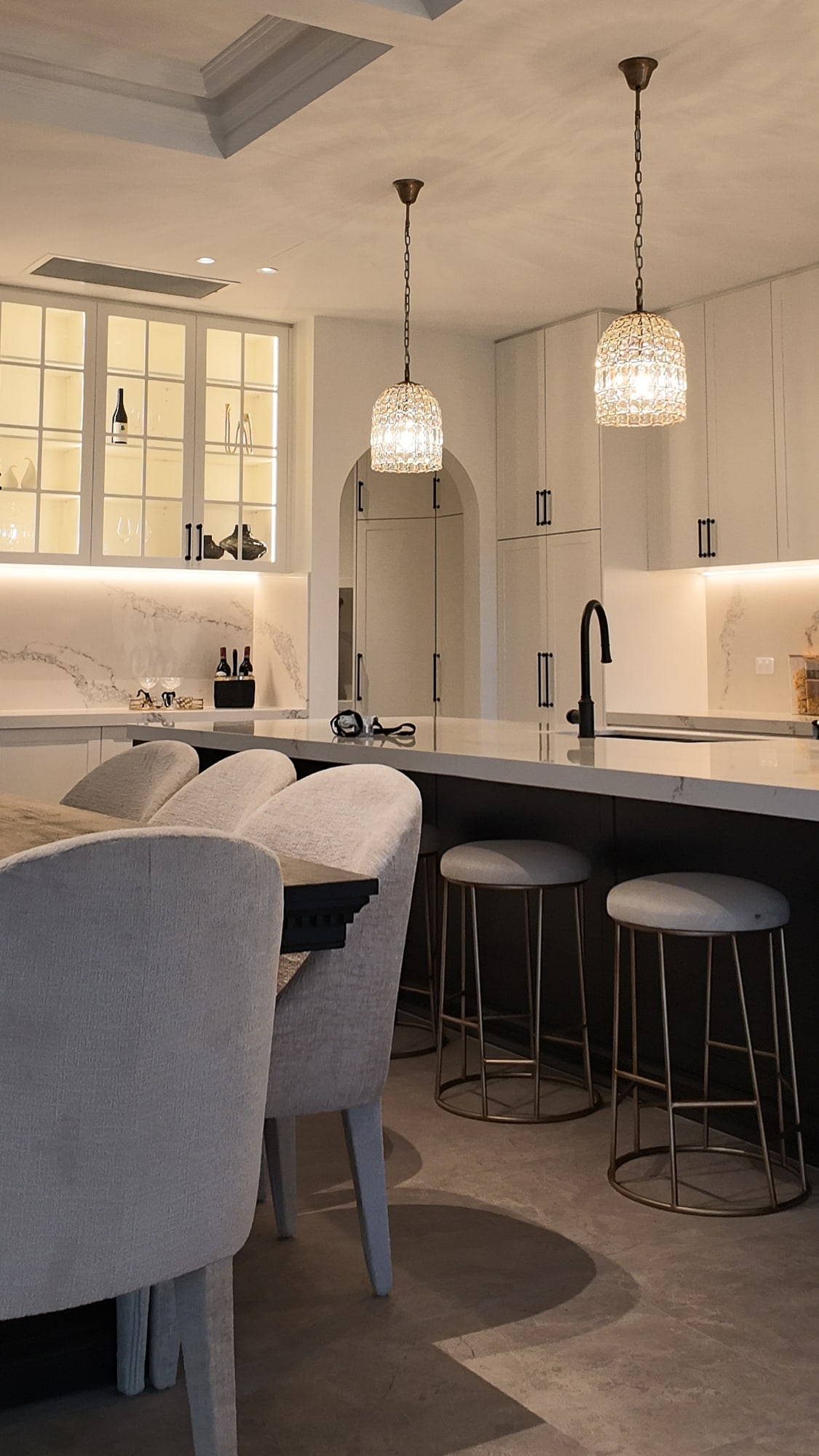 Kitchen island with bar stools and glass pendant lights
