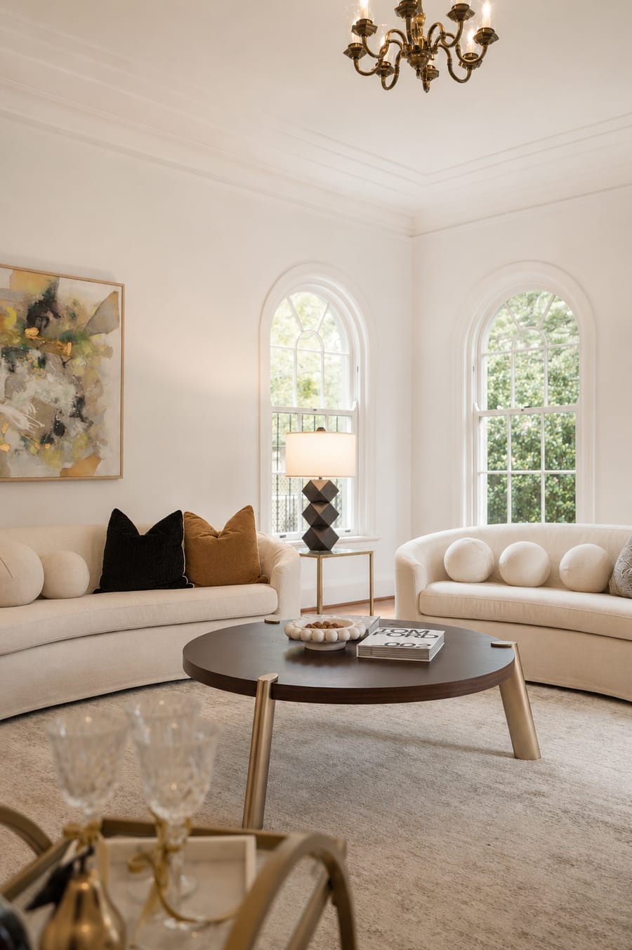 Living room with curved sofas and twin arched windows